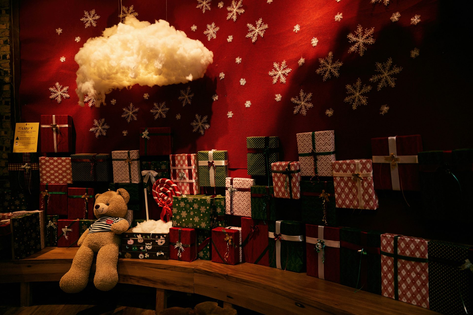 Teddy bear with christmas gifts and snowflakes