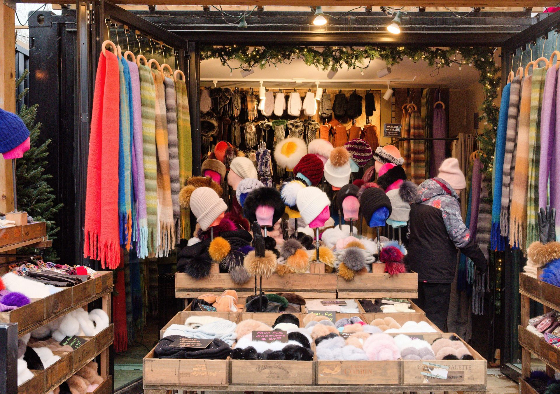 Colorful scarves and hats on display at a Toronto winter market stall.