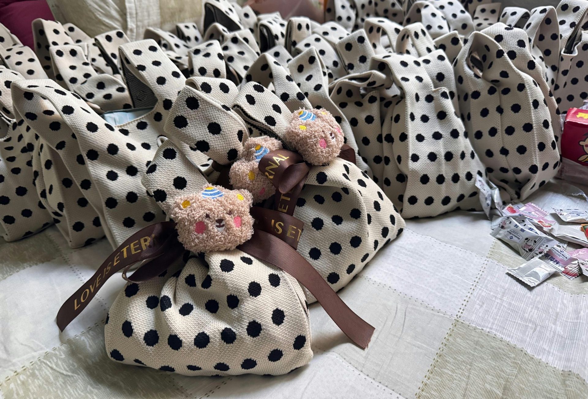 Many polka dot gift bags with teddy bear decorations